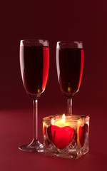 wineglasses and candle on the white background
