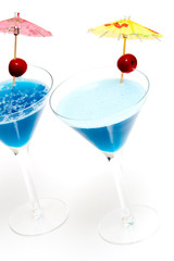 two cocktails with blue curacao isolated on white