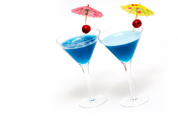 two cocktails with blue curacao isolated on white