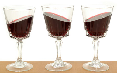 three wineglasses and gravity