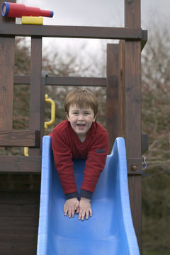 Boy On A Garden Slide