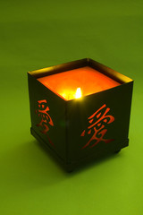 candle with hieroglyph on green