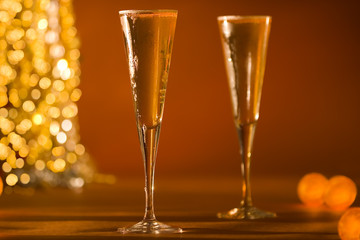 close-up of fluted champagne glass's & glowing golden lights