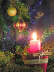 burning red candle and christmas-tree