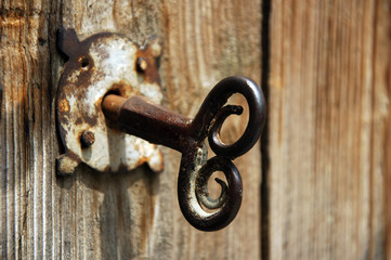 old house key in wooden doors.