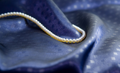 pearl necklace on dark blue silk
