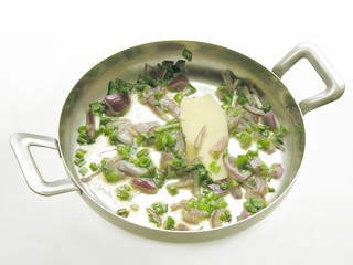 onion fried with butter on a frying-pan