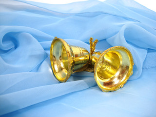 golden christmas handbells on blue background