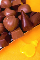 chocolate candies on yellow background