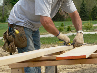 carpenter prepares to cut