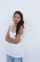 asian girl standing in front of a white wall