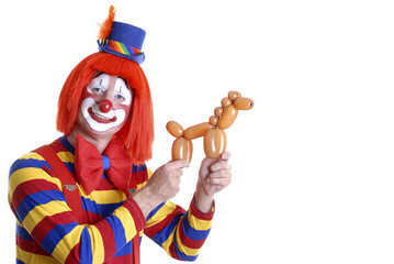 smiling clown holding a balloon animal
