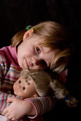 Fototapeta na wymiar little girl with a doll