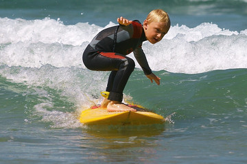 a youngster learning to surf