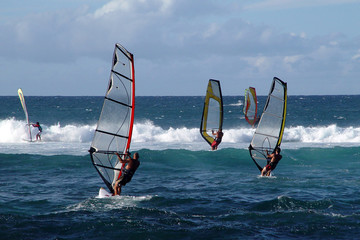 People windsurfing on high waves