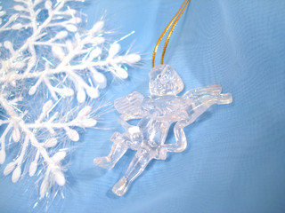 angel sculpture and snowflake on blue background