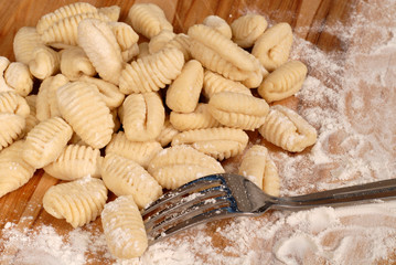 freshly made potato gnocchi on a floured cutting board
