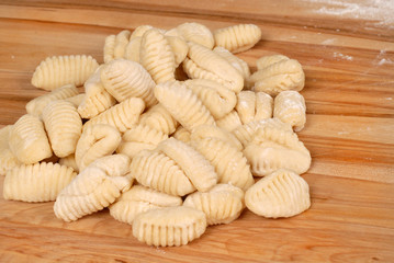 freshly made potato gnocchi on a cutting board