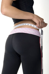 woman measuring her waist