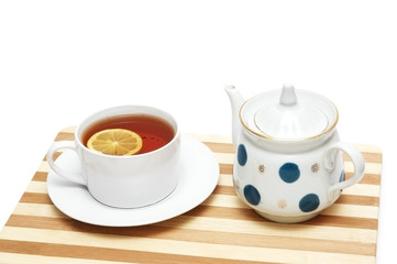 cup of tea with lemon and pot isolated on the whit