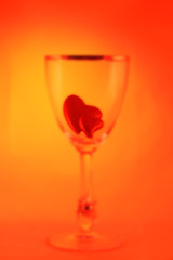 abstract blurred picture of a glass filled with two little heart