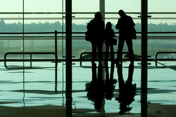 family waiting at the international airport terminal