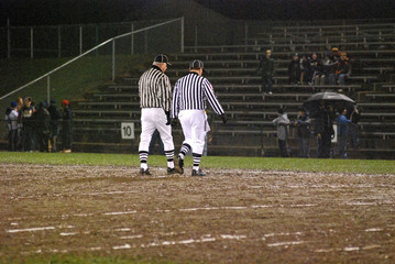 referees in the mud