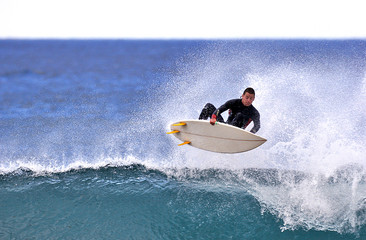 surfer executing an ariel maneuver