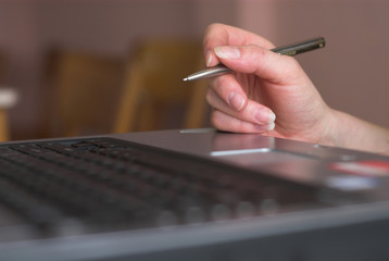 hand, pen, laptop