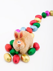 Fototapeta na wymiar easter toy rabbit with some choclate eggs
