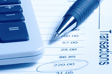 calculator and pen on financial statement