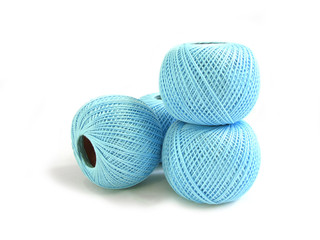four balls of blue string on a white background