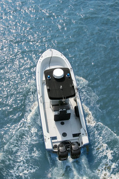 Motorboat Racing Across Water, Overhead View