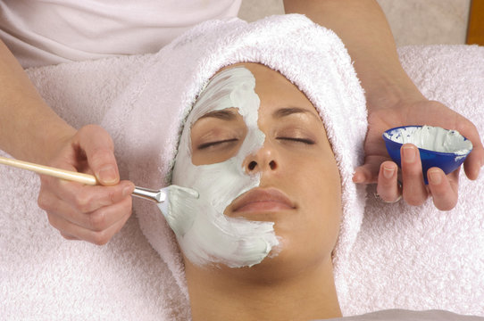 spa esthetician applying organic facial masque