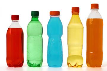 five colored bottles with juice
