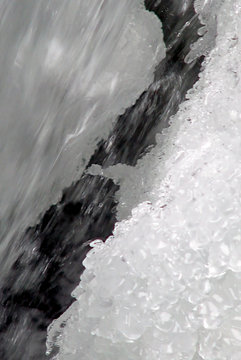 snow and ice over flowing water