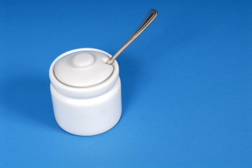 white sugar bowl on a blue background