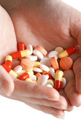 heap of pills in two woman hands