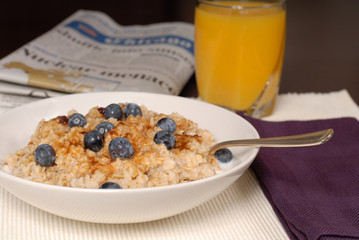 a bowl of oatmeal with brown sugar and blueberries