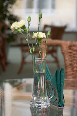 glass ahtray and flowers on a glass table in a cafe. shallow dof