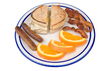 breakfast of eggs, bacon,sausage,orange