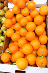 oranges in a market stall, cornwall, uk.