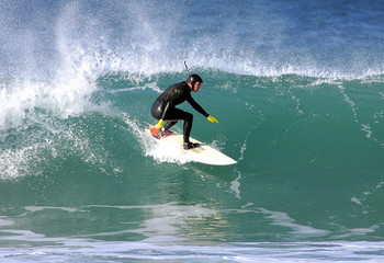 a surfer in trim on a wave