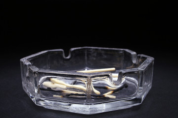 ashtray with burned matchsticks