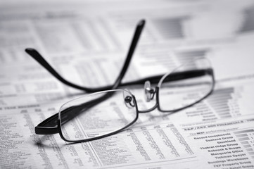 glasses on a newspaper