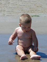 baby playing on the seaside