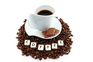 cup of coffee on coffee beans