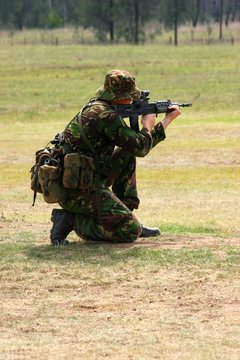 soldier firing a rifle