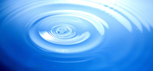 whirlpool on the surface of the water just after a drop has made contact with it