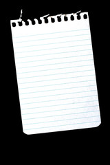 torn notebook page on black